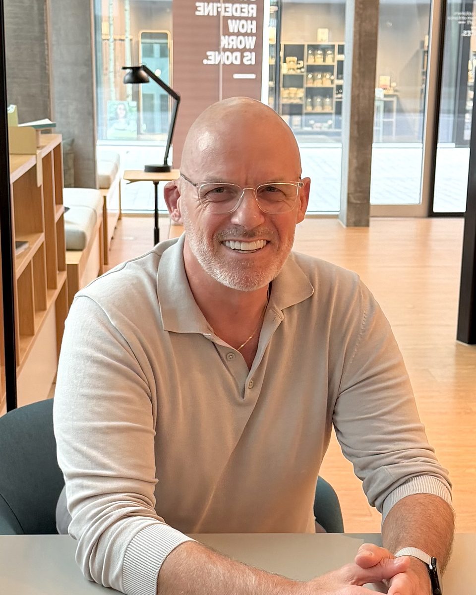 Adrian Scarfe, Founder & Principal Consultant of WisePath Solutions, smiling at a table